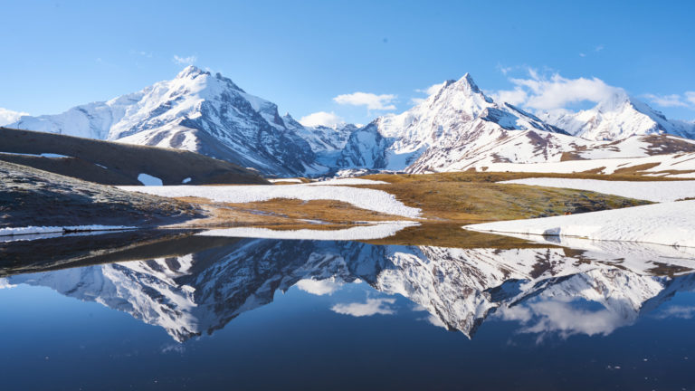 Experience the beauty of Maydakul Lake against a backdrop of snowy peaks