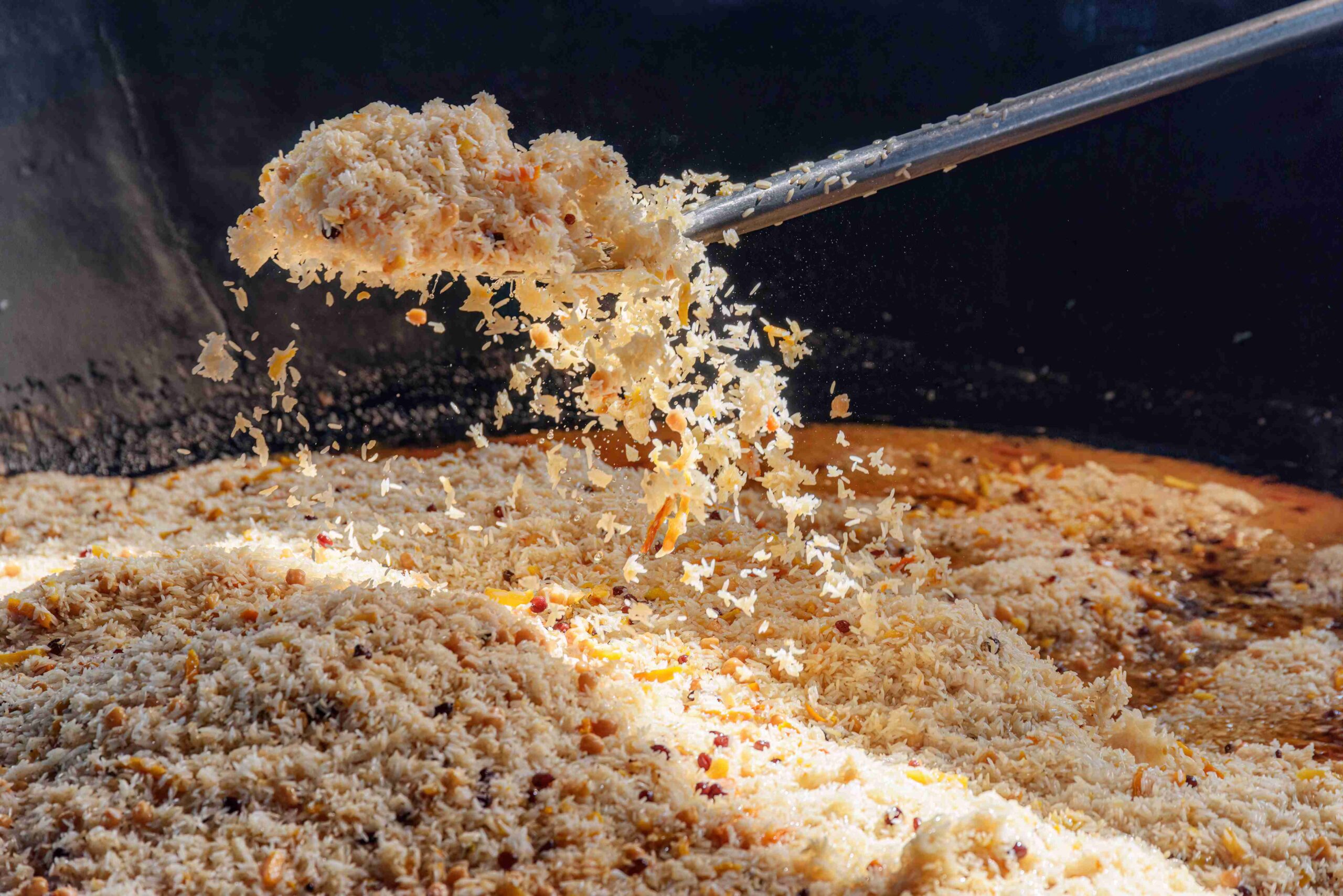 Dramatic action shot of rice being sprinkled during the cooking process