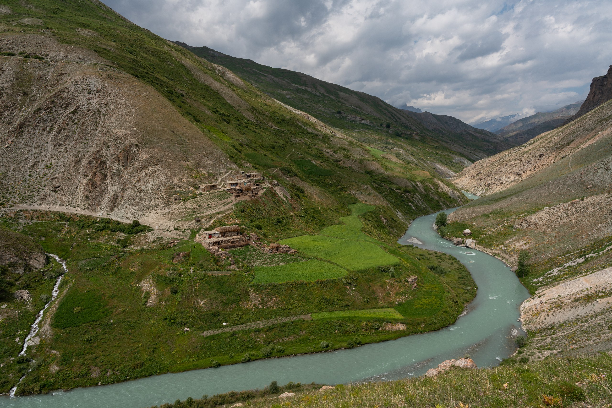 Ancient Sogdian mountain village perched on green terraced slopes